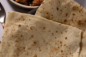 Roomali roti prepared from dough which contains whole wheat Flour (atta) maida (flour) oil and water. It can be served with rich curries (veg/non-veg).